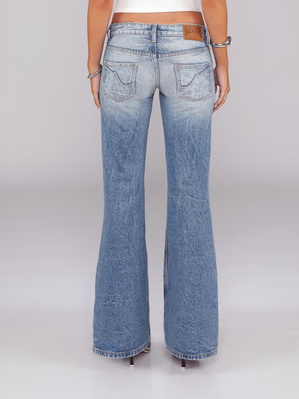 Flared Denim Jeans With A Retro Y2K Vibe Featuring A Washed And Distressed Finish For A Cool Edgy Look